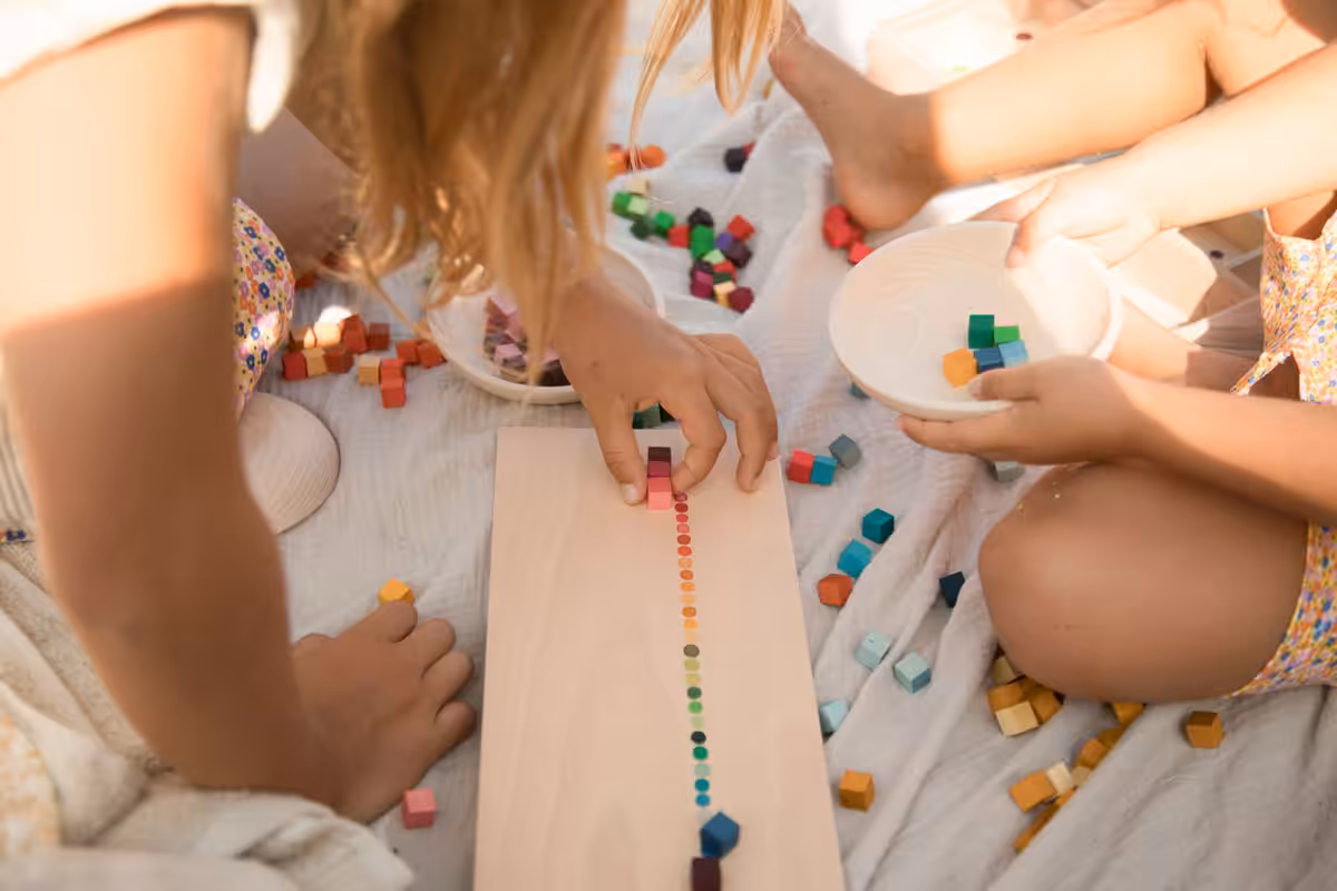 ‘Mis and match’ is a collection of colourful cubes in a wooden sorting box.